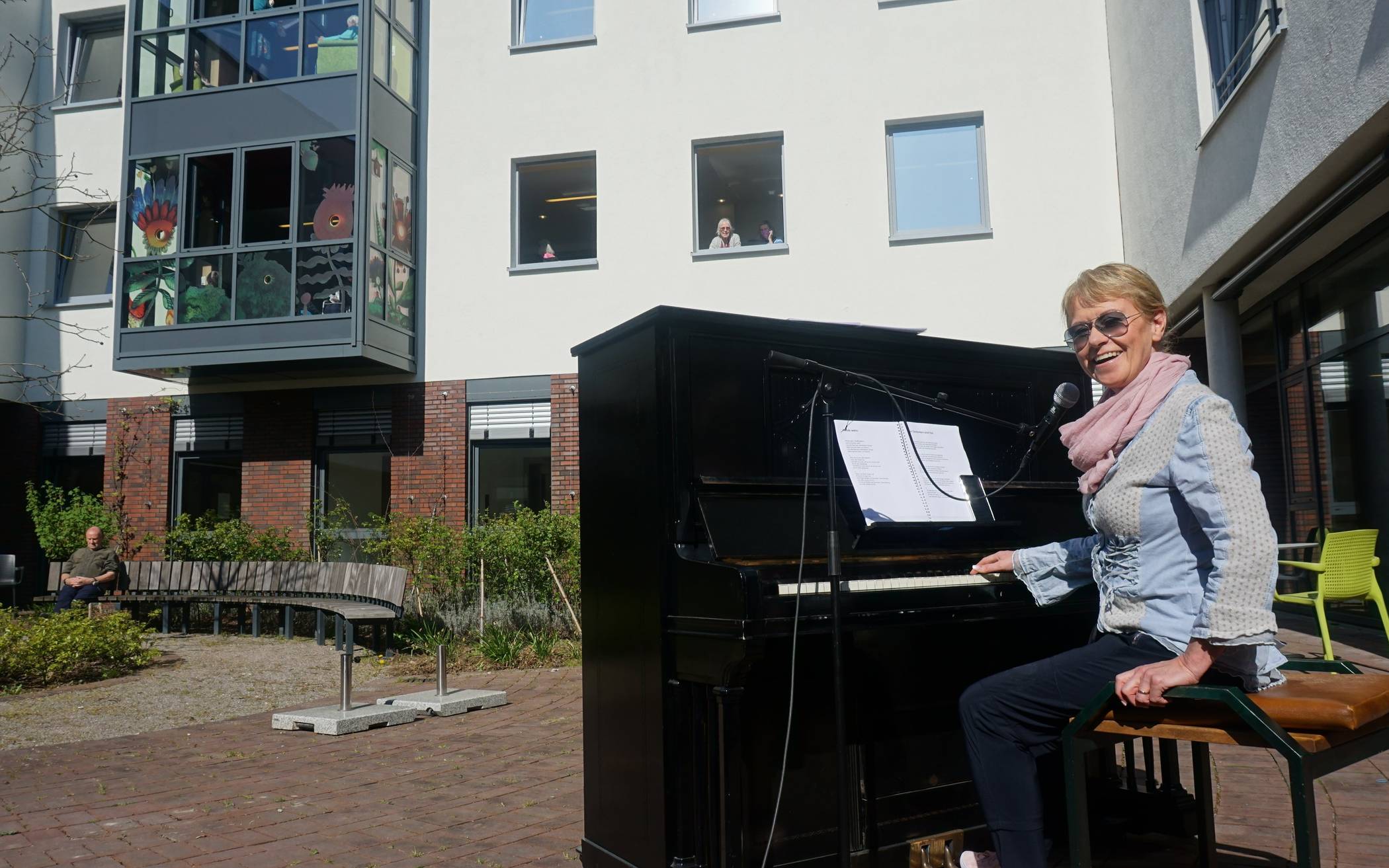  Mit dem Klavierkonzert im Innenhof sorgte Pianistin Eva Lange für gute Stimmung. Die Bewohner des Memory Zentrums schauten aus den offenen Fenstern zu. 